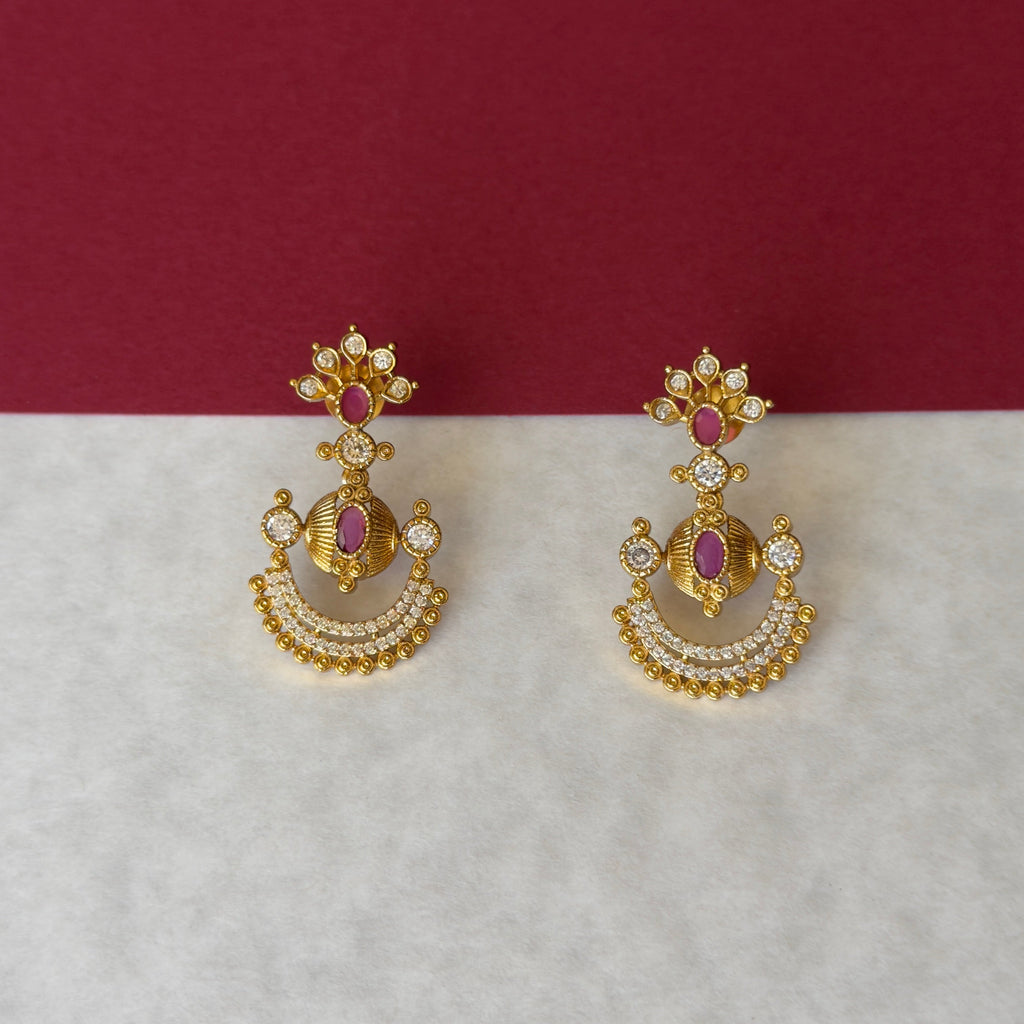 Gold-tone necklace with ruby-color and clear stone accents