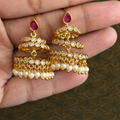 Pair of tiered gold-tone earrings with pink teardrop tops, clear stones and pearl-like drops