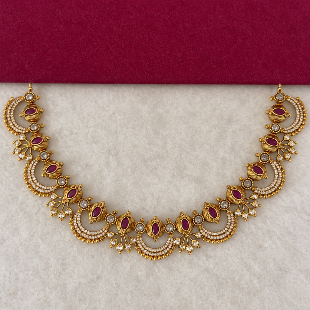 Pair of gold-tone drop earrings with ruby-color and clear stone accents